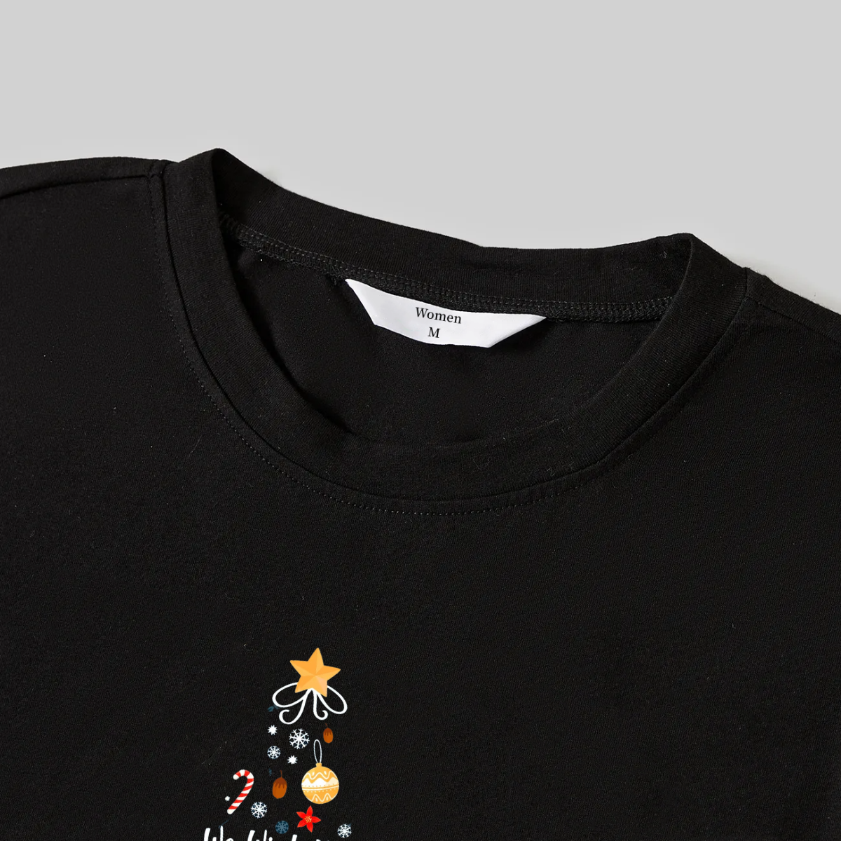 Luvik | "Toivotamme teille Hyvää Joulua" printattu kuvio musta pitkähihainen paita mustilla ja vihreillä ruudullisilla housuilla perheelle sopivat pyjamat