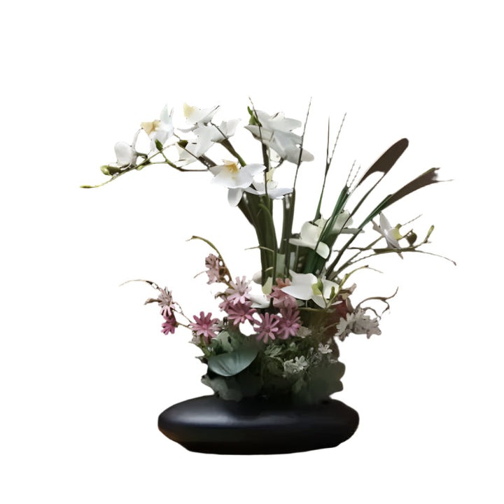 Livaktig blomsterarrangement i en moderne vase Luvikno