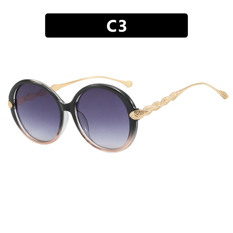 Dame stor rund solbrille med dekorative metalakser Luvikno