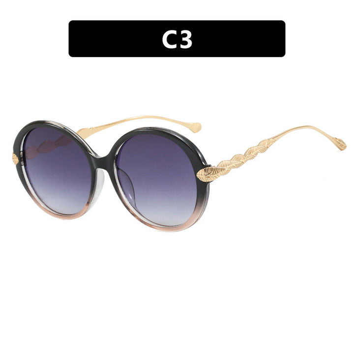 Dame stor rund solbrille med dekorative metalakser Luvikno