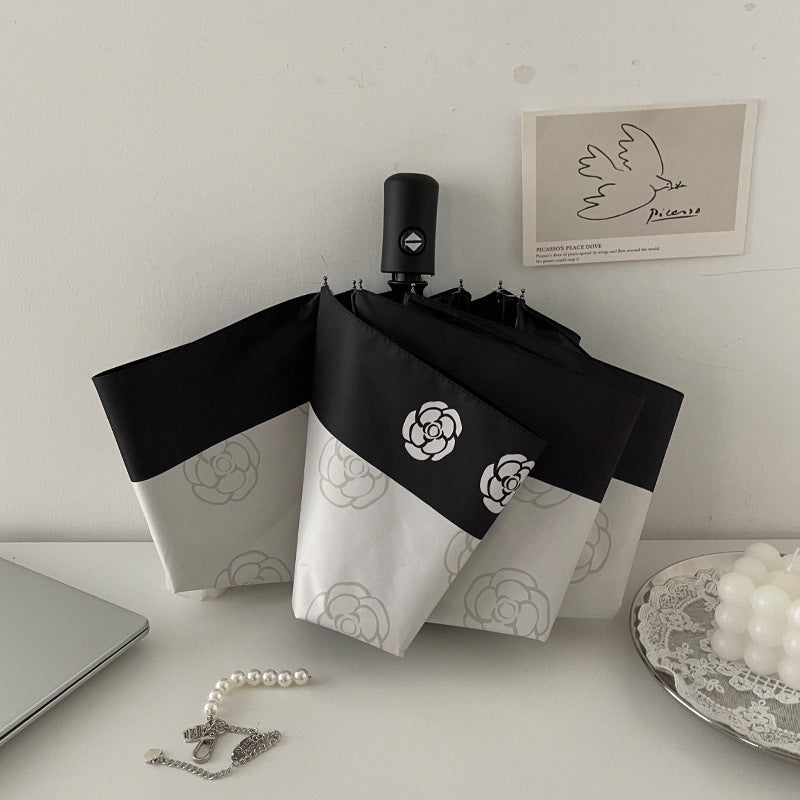 Dame elegant paraply med stilfullt blomsterdesign Luvikno