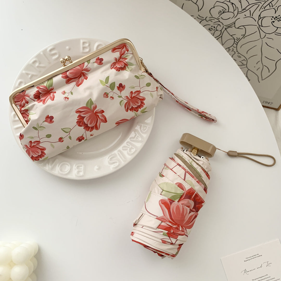 Damer elegant foldeparaply med blomsterdesign og praktisk etui Luvikno