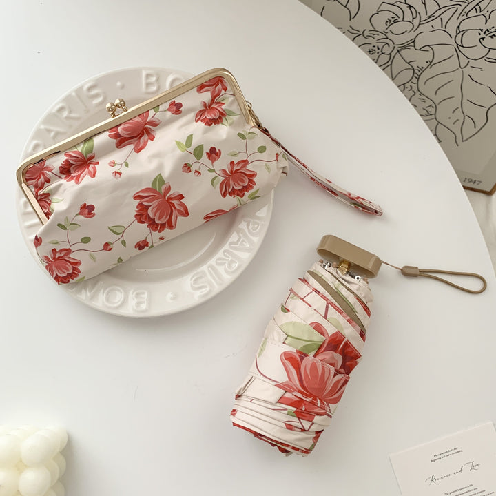 Damer elegant foldeparaply med blomsterdesign og praktisk etui Luvikno