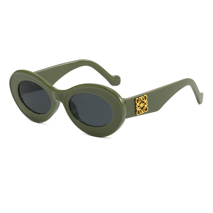 Dame moteriktig solbrille med oval ramme og gullapplikasjoner Luvikno