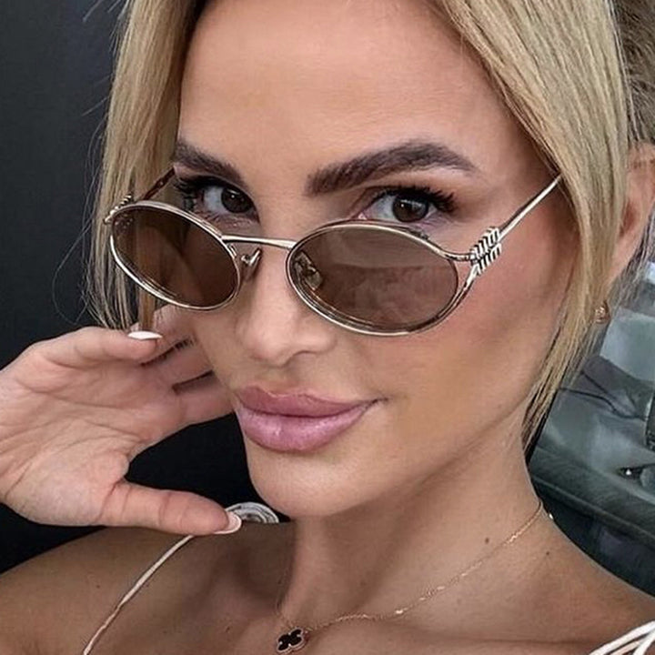Dame ovalformet solbrille med elegant metallramme og moderne design Luvikno