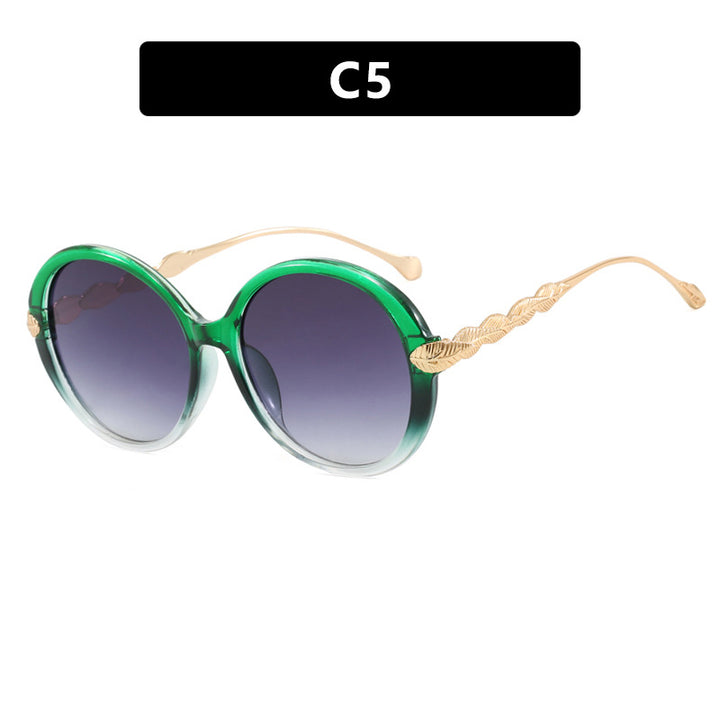 Dame stor rund solbrille med dekorative metalakser Luvikno
