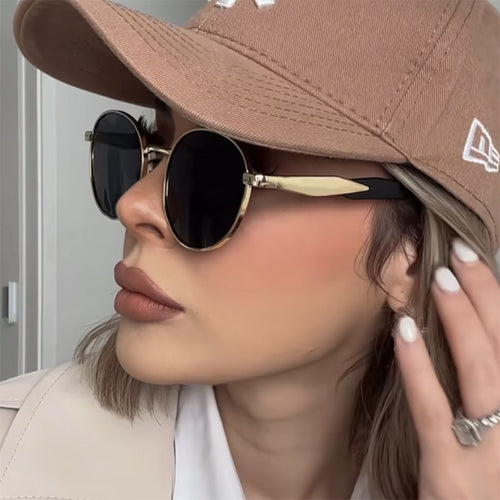 Dame rund solbrille med elegant, gullramme og UV-beskyttelse Luvikno