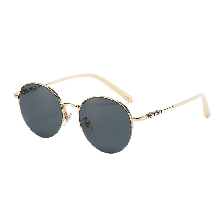 Dame rund solbrille med elegant metallramme og komfortable nesepads Luvikno