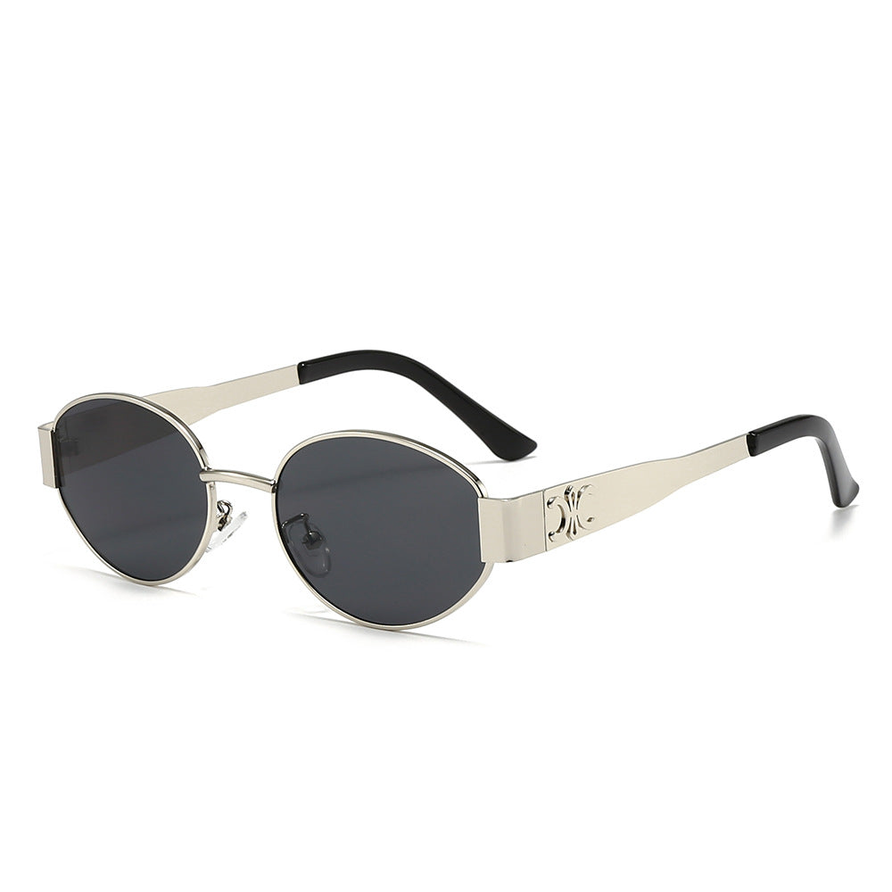 Dame Designer-solbrille med elegant oval ramme og unike aksenter Luvikno