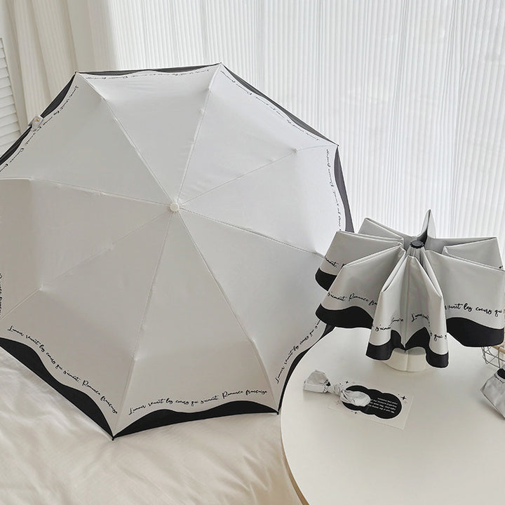 Dame sammenleggbar paraply med stilfull design og praktisk lagringssystem Luvikno