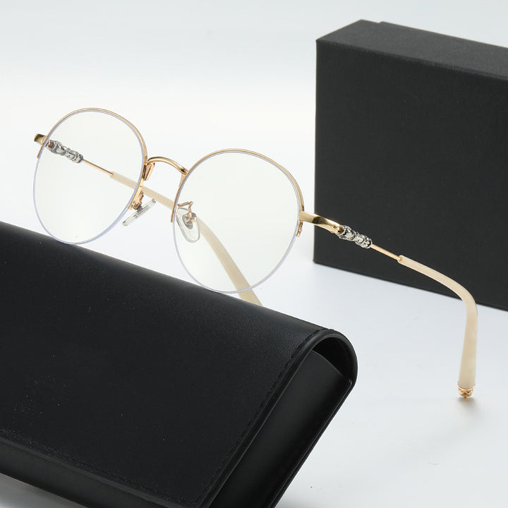 Dame rund solbrille med elegant metallramme og komfortable nesepads Luvikno