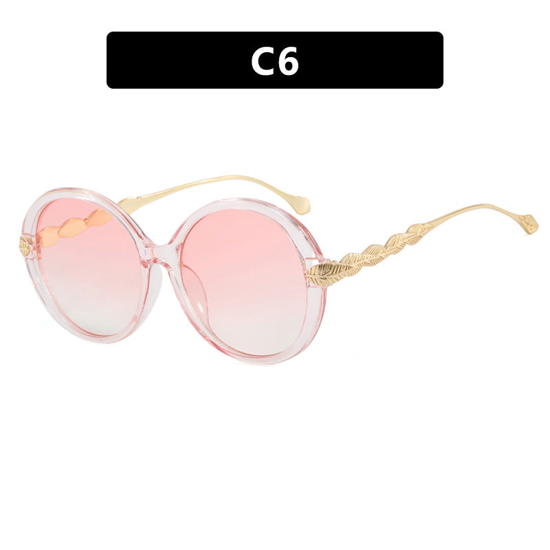 Dame stor rund solbrille med dekorative metalakser Luvikno