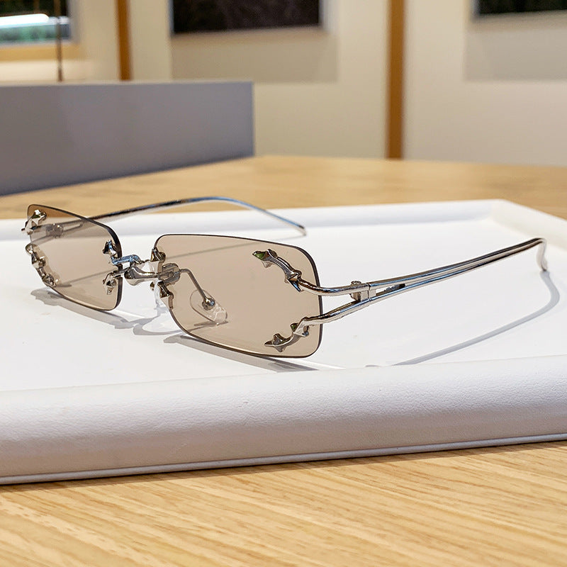 Dame moteriserte solbriller med filigran metallramme og transparente glass Luvikno