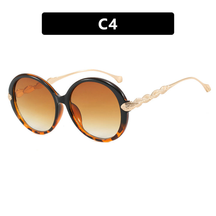 Dame stor rund solbrille med dekorative metalakser Luvikno