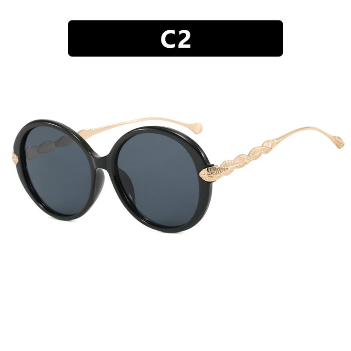 Dame stor rund solbrille med dekorative metalakser Luvikno