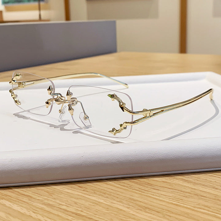 Dame moteriserte solbriller med filigran metallramme og transparente glass Luvikno