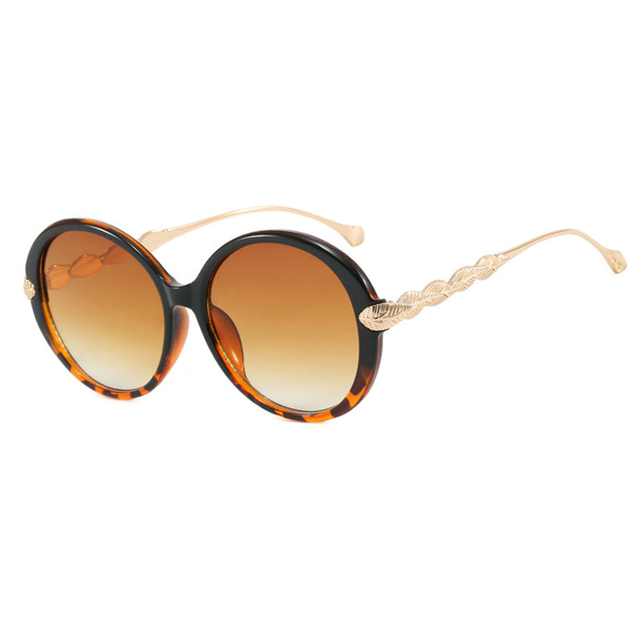 Dame stor rund solbrille med dekorative metalakser Luvikno