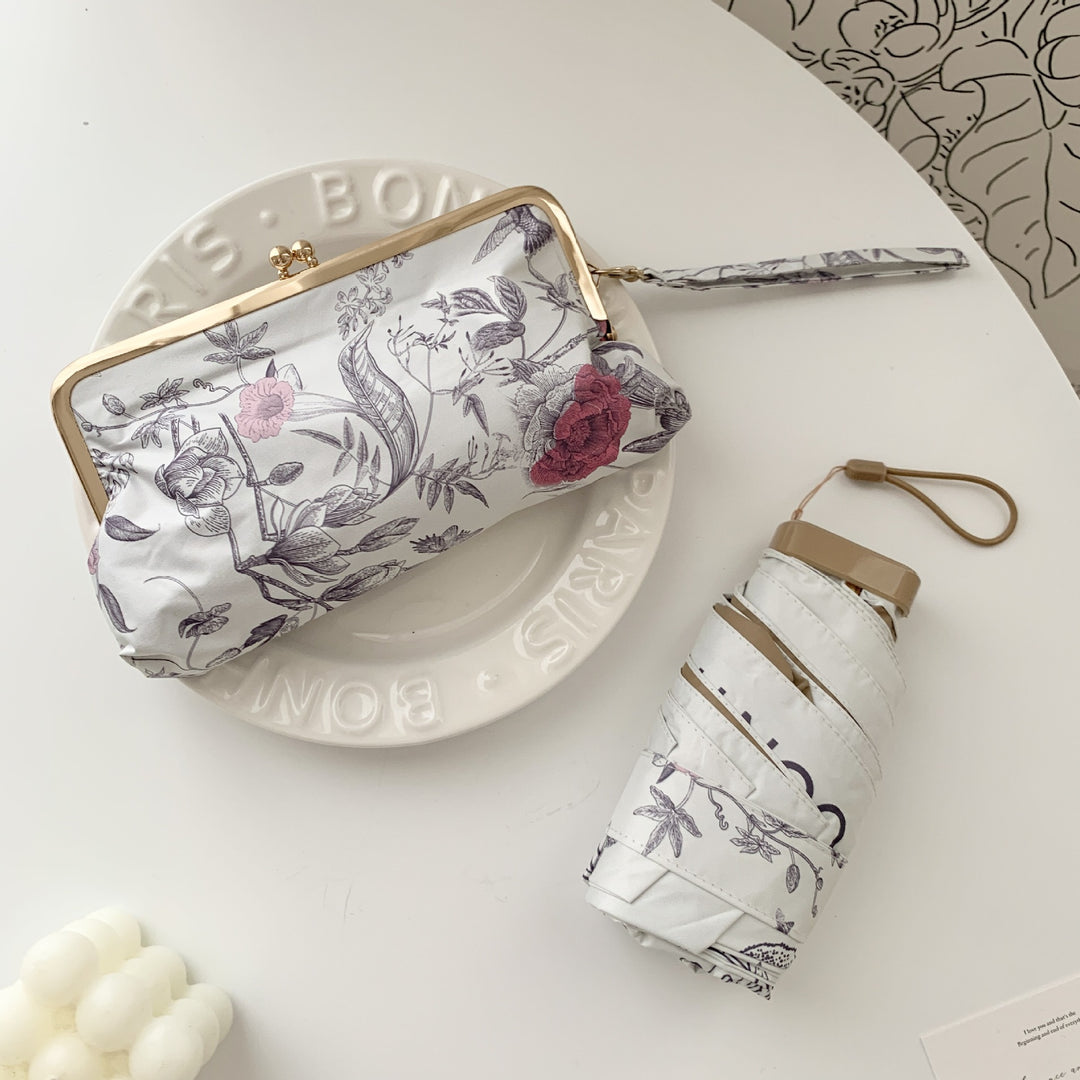 Damer elegant foldeparaply med blomsterdesign og praktisk etui Luvikno