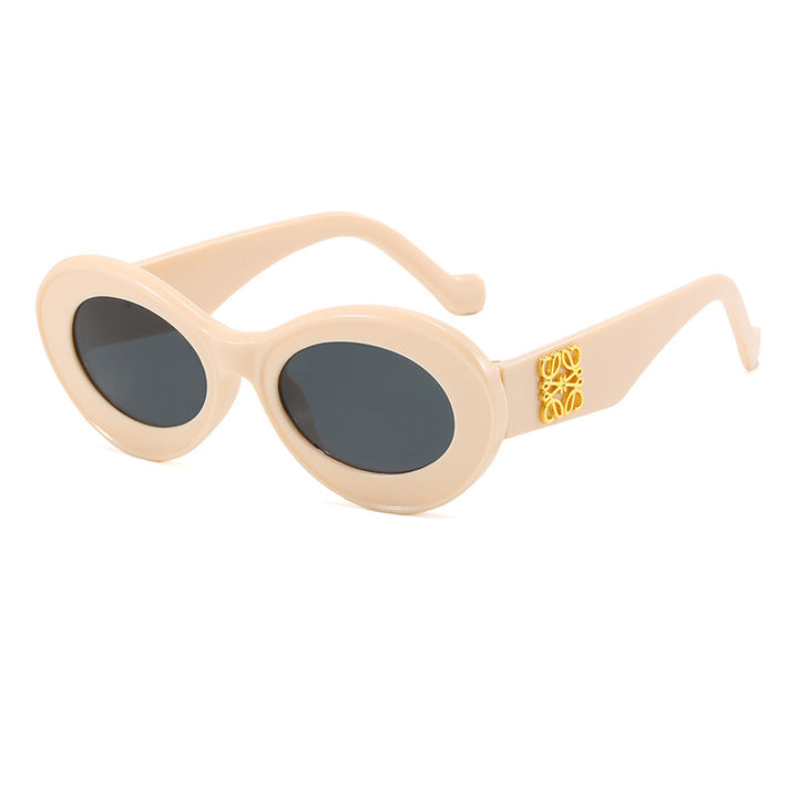 Dame moteriktig solbrille med oval ramme og gullapplikasjoner Luvikno