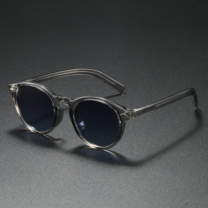 Dame Rund-solbrille med transparent ramme og reflekterende glass Luvikno