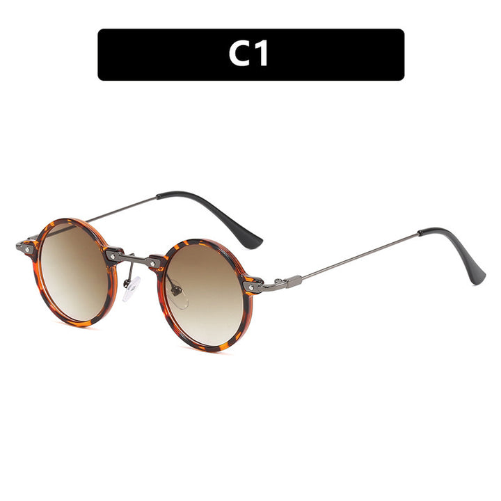 Dame rund solbrille med moderne metallramme og store blå linser Luvikno