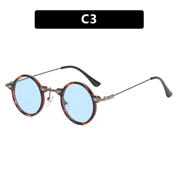 Dame rund solbrille med moderne metallramme og store blå linser Luvikno