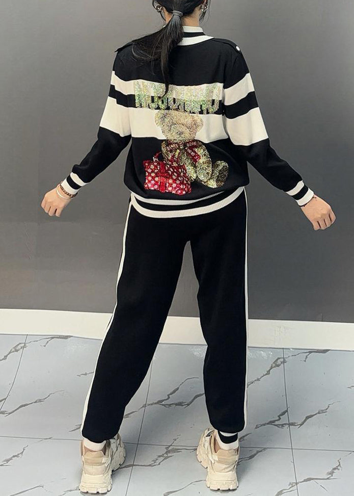 Luvik | Musta puolipaneeli kauluksella oleva patchwork-takki ja leveälahkeiset housut Kaksiosainen asu